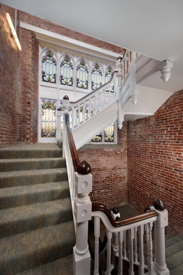 joli escalier dans eglise transformee en maison brique rouge