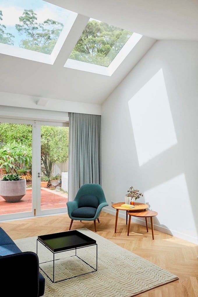 salon véranda toit cathédrale lumineux mur blanc rideau bleu gris