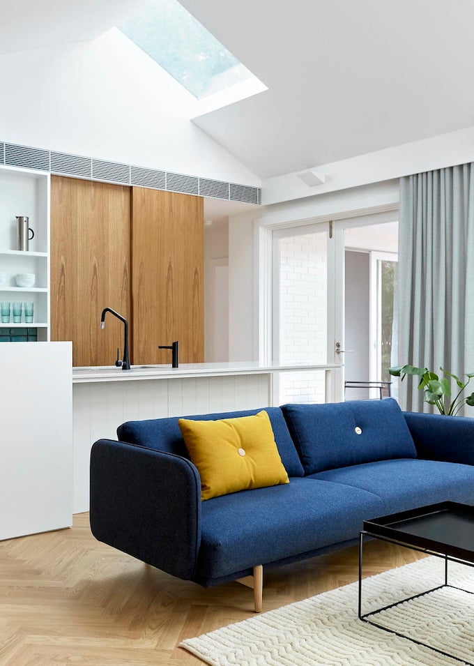 maison avec puits de lumière canapé bleu coussin jaune salon parquet tapis porte coulissante blog déco clem around the corner