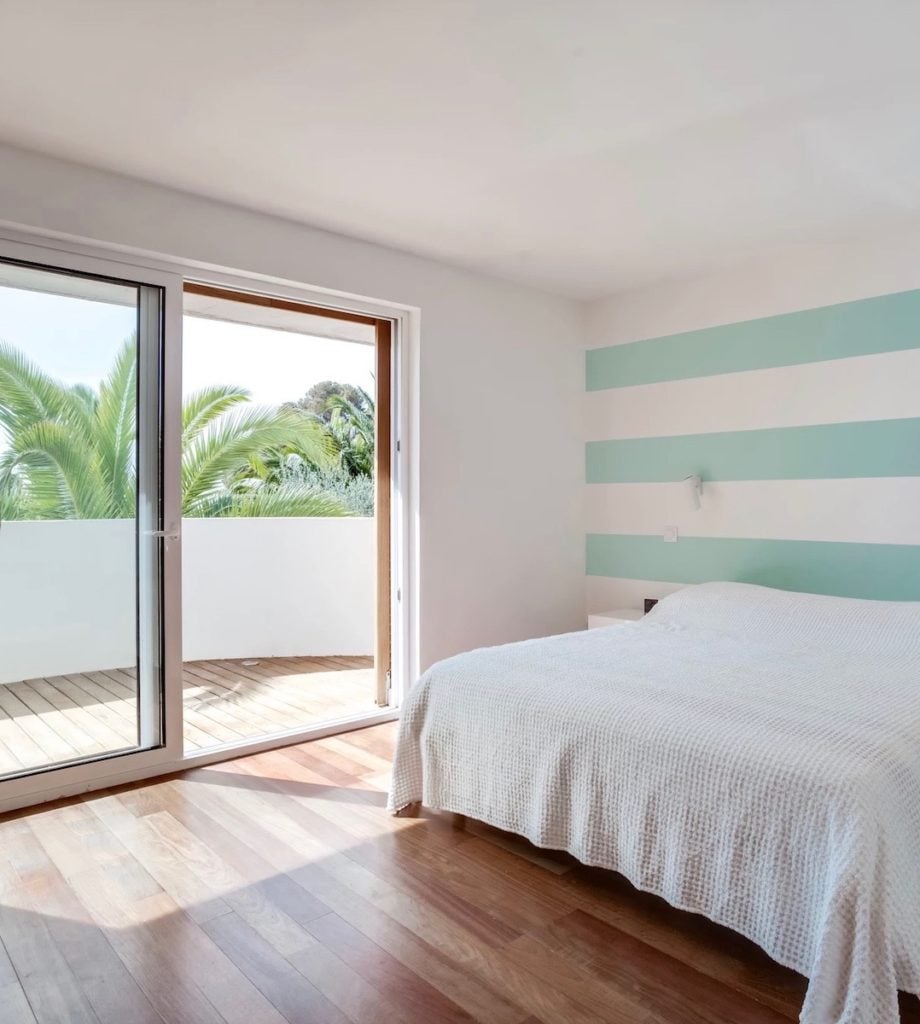 chambre avec balcon baie vitrée lit parquet bois mur bleu marinière clemaroundthecorner