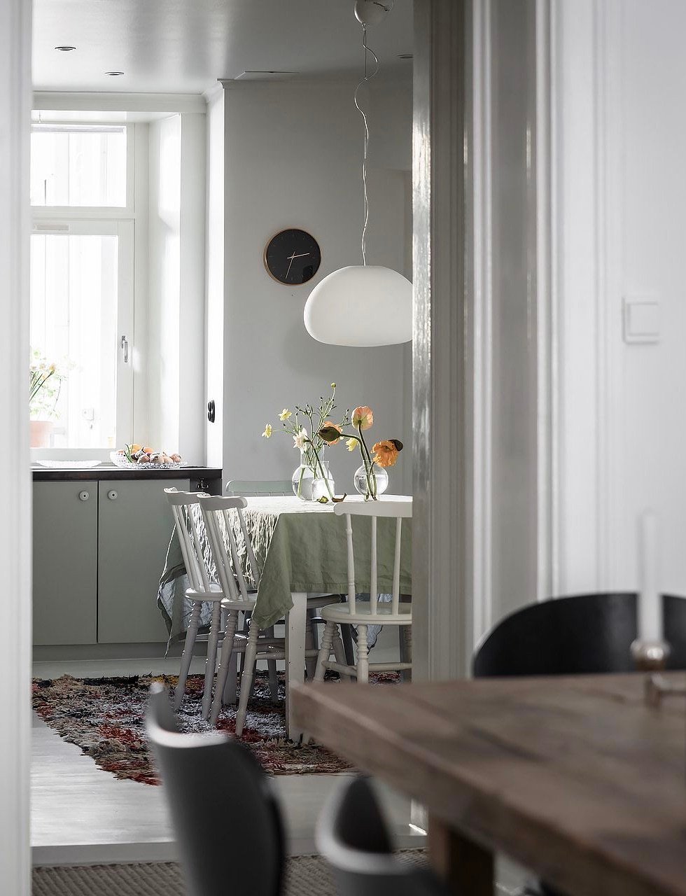 cuisine verte claire ouverte sur salon blanc nappe lin lavé