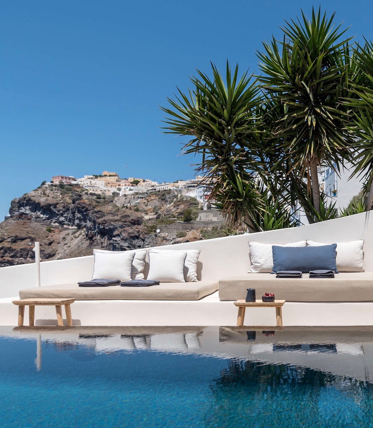 Porto Fira Suites villa Santorin maison blanche piscine falaise table basse tabouret bois flotté