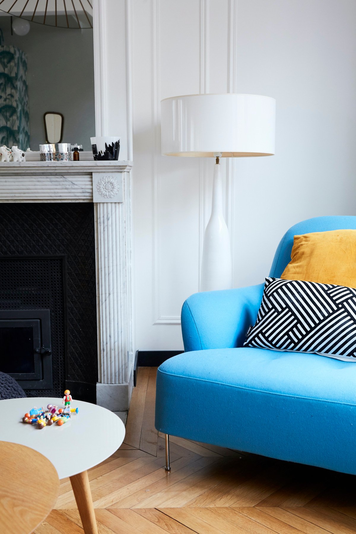 salon traditionnel parisien décoration intérieur cheminée marbre miroir doré fauteuil bleu clair