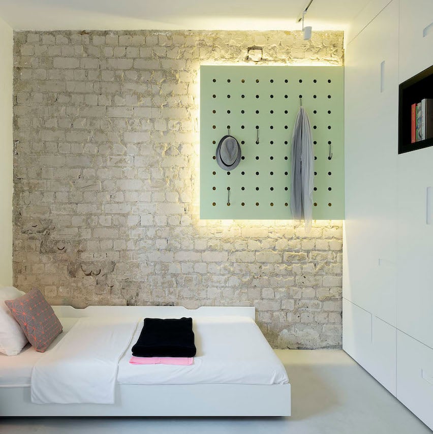 chambre sans fenêtre mur brique néons lumineux lit double