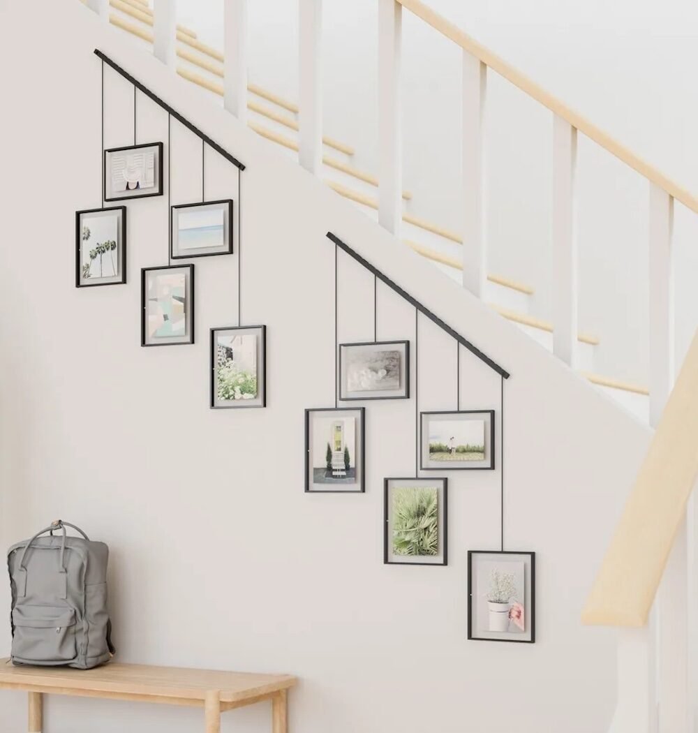 hall d'entree escalier blanc commode bois mur de cadre photo