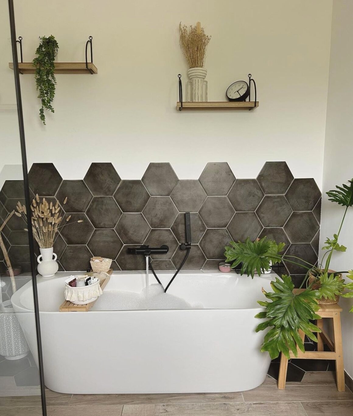 baignoire oval blanche mur carrelage gris beton parquet bois