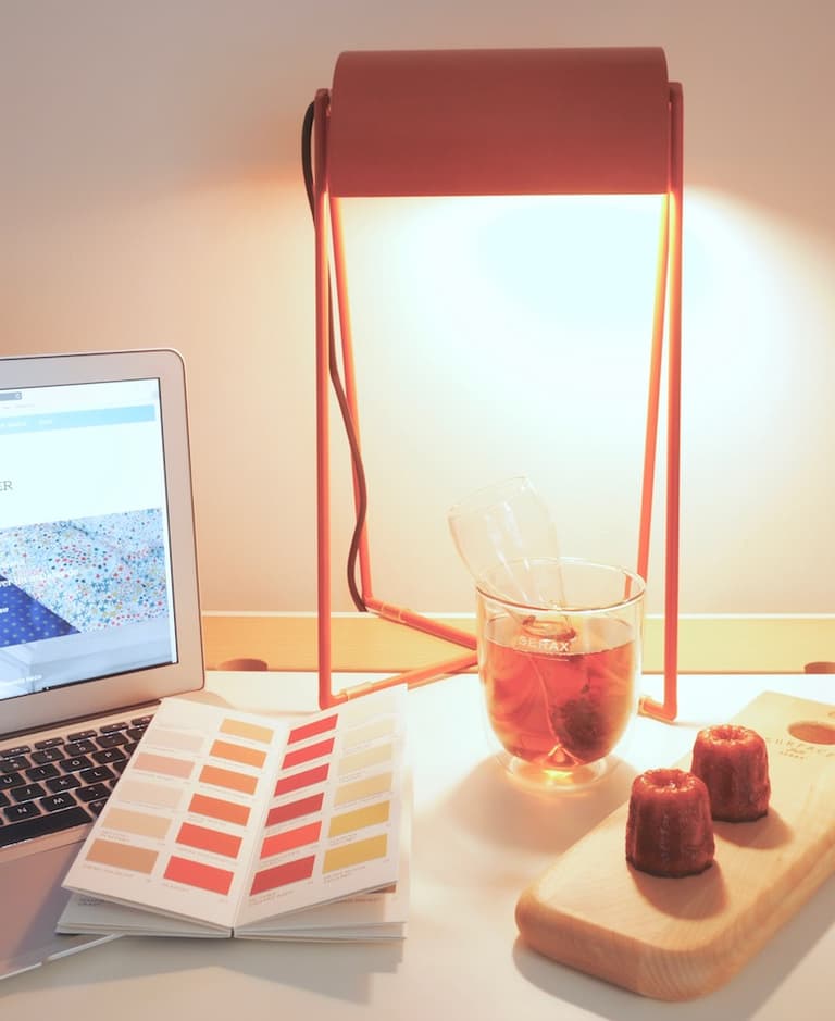 Pause gourmande au bureau avec thé, cannelés et accessoires rouges et blancs