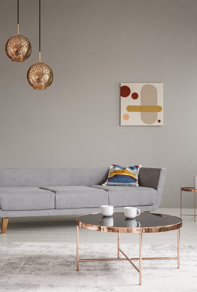 salon élégant canapé gris scandinave table basse ronde cuivre