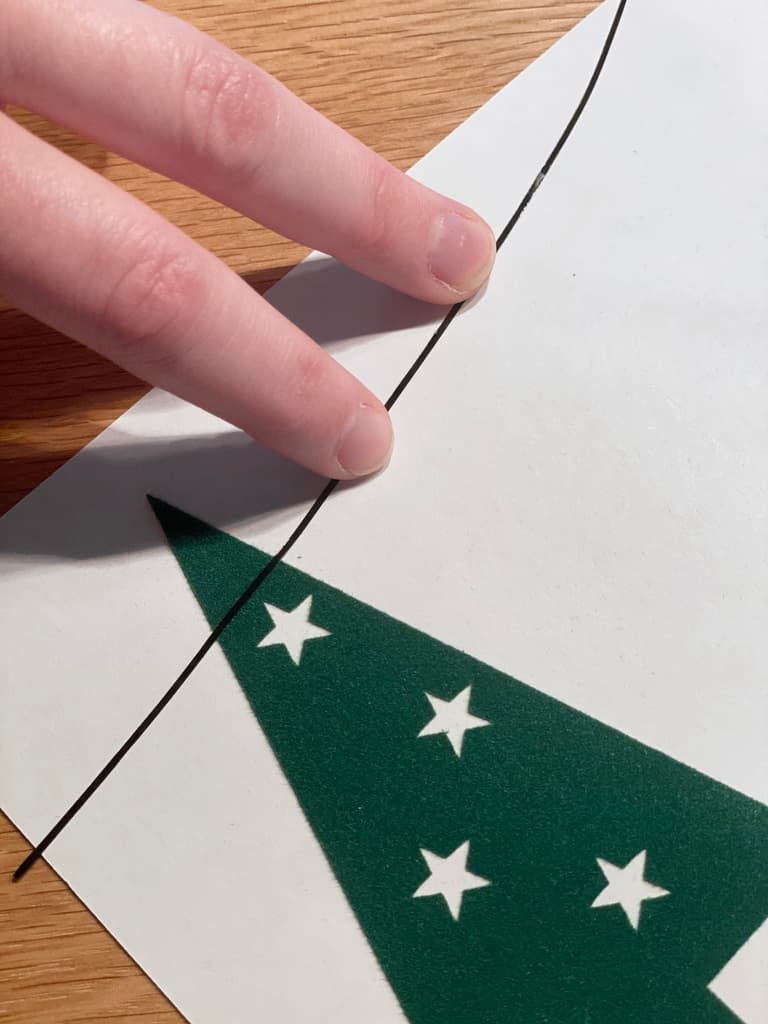 Positionnement d’un sapin vert décoré d’étoiles blanches sur une page de calendrier