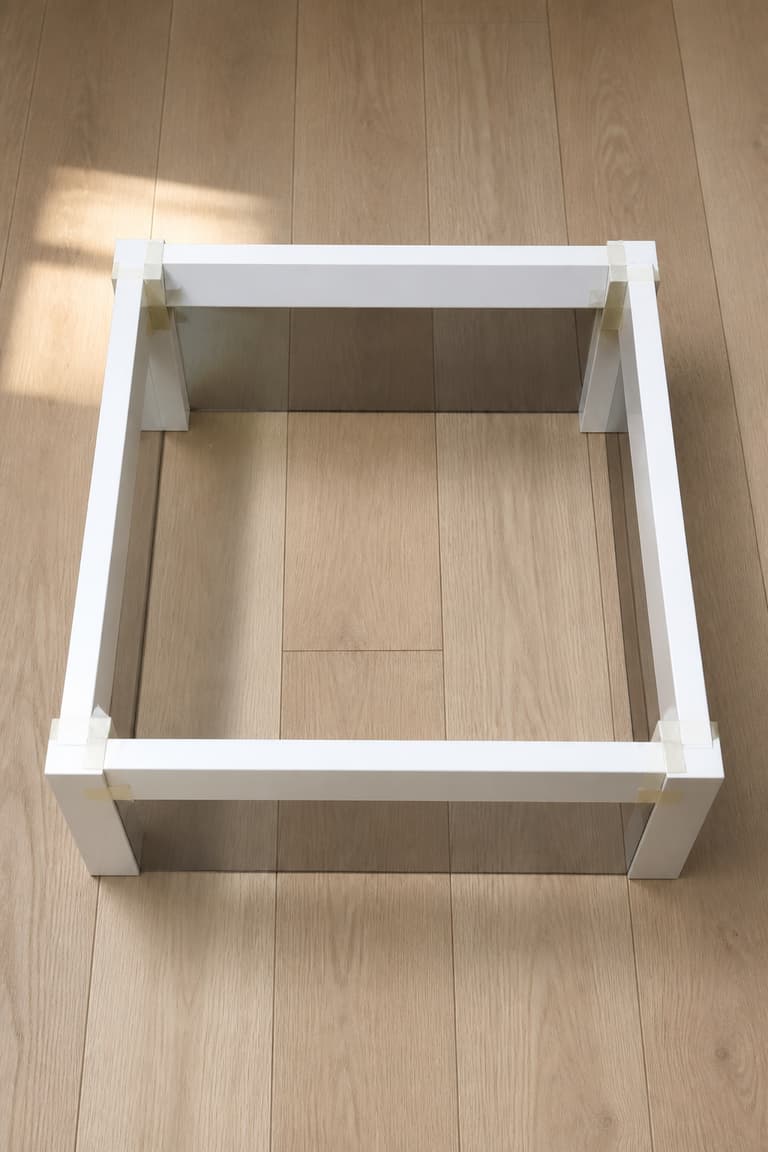 Structure carrée en cours d’assemblage pour une table Lack