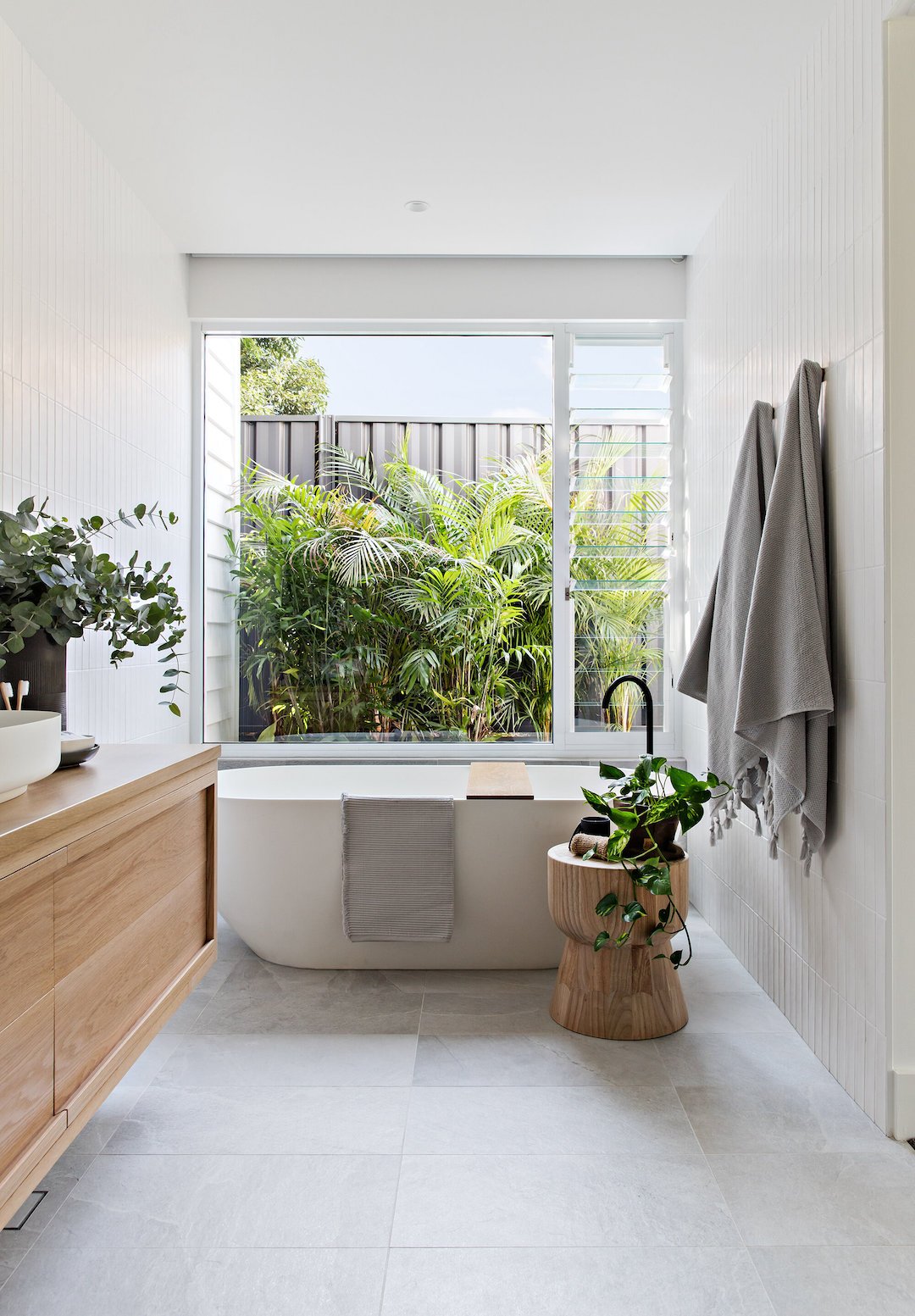 salle de bain lumineuse zen épurée végétale baignoire ovale blanche mobilier bois